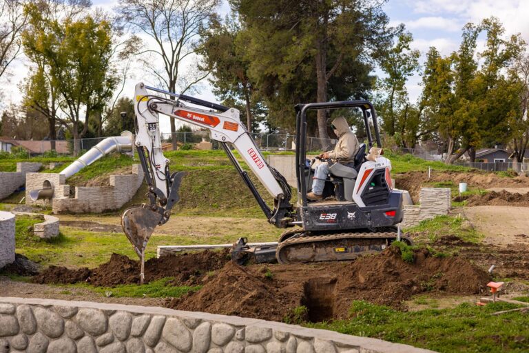 Backhoe being operated for the landscape construction of the Awesome Spot Playground in Modesto, CA